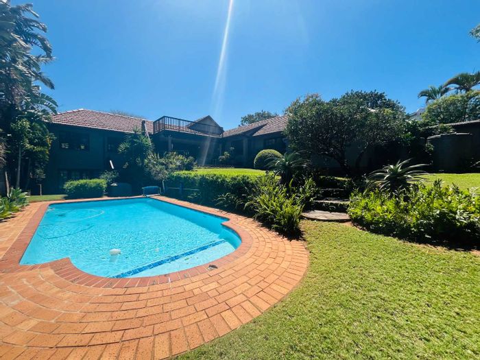 Four-bedroom house for sale in Durban North Central with flat, pool, and solar amenities.