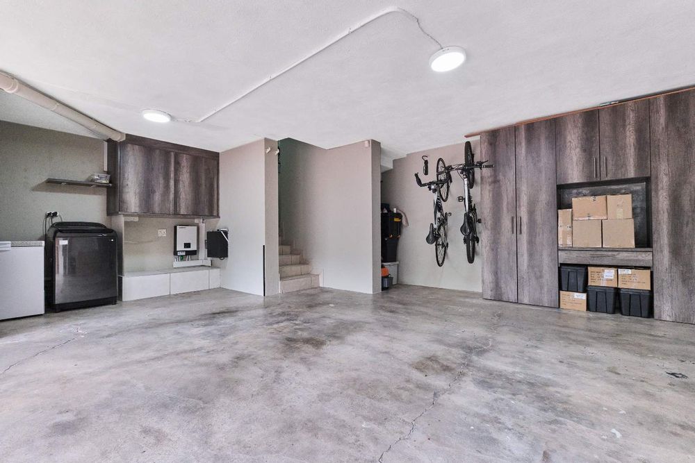 Garage with built-in-cupboards, laundry and backup power system.