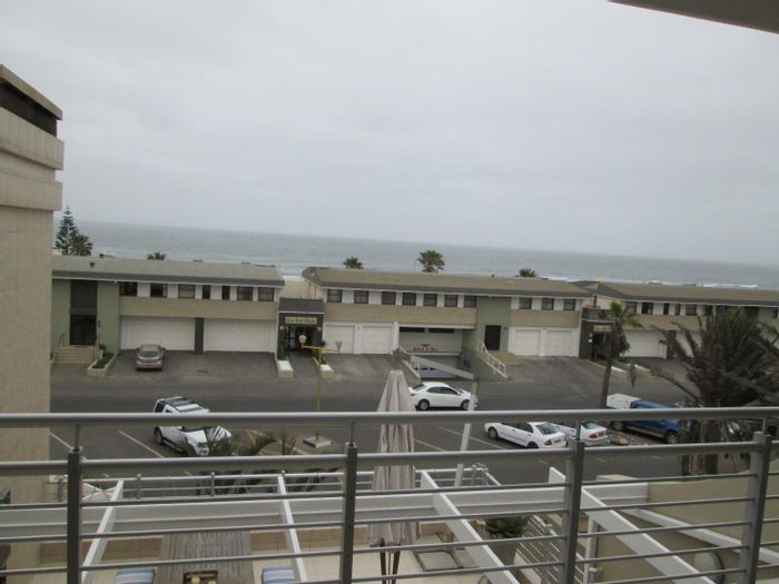 For Sale: Spacious 4-bedroom apartment in Swakopmund Central with sea views, balcony, and bar.