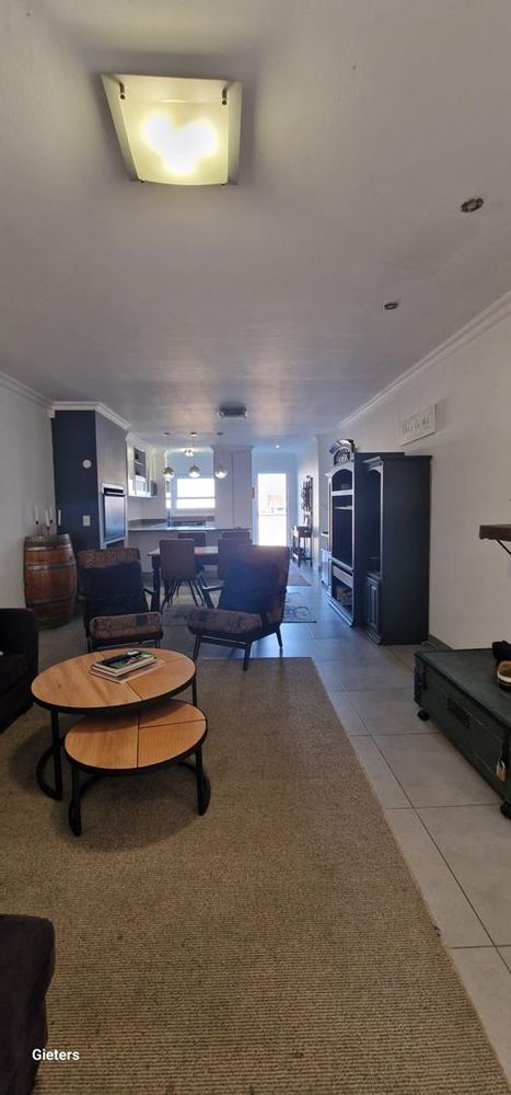 Spacious tv area with sliding doors opening onto a very spacious stoep area