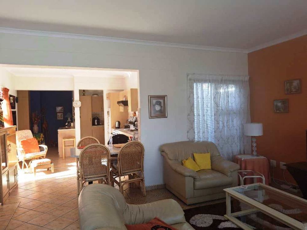 Open plan tv aea, kitchen, indoor BBQ and separate scullery
