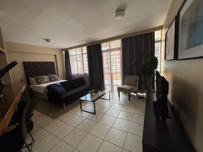 Braamfontein Apartment For Sale: Secure living near Wits, balcony, ideal investment.