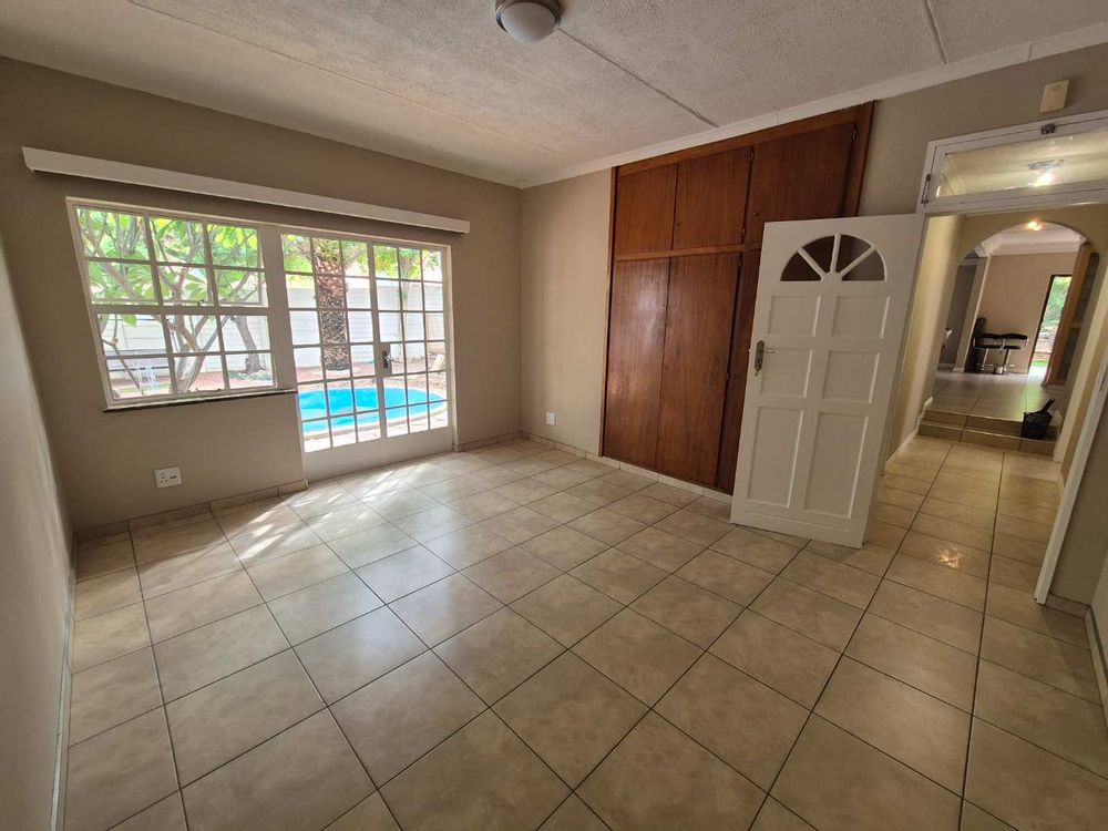 Second bedroom of main house looking out on pool