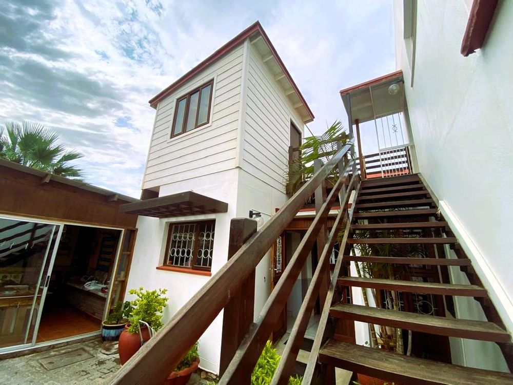 Inner courtyard. Enclosed entertainment area with BBQ, entrance to kitchen and stairs to one of the bedrooms and flat 1