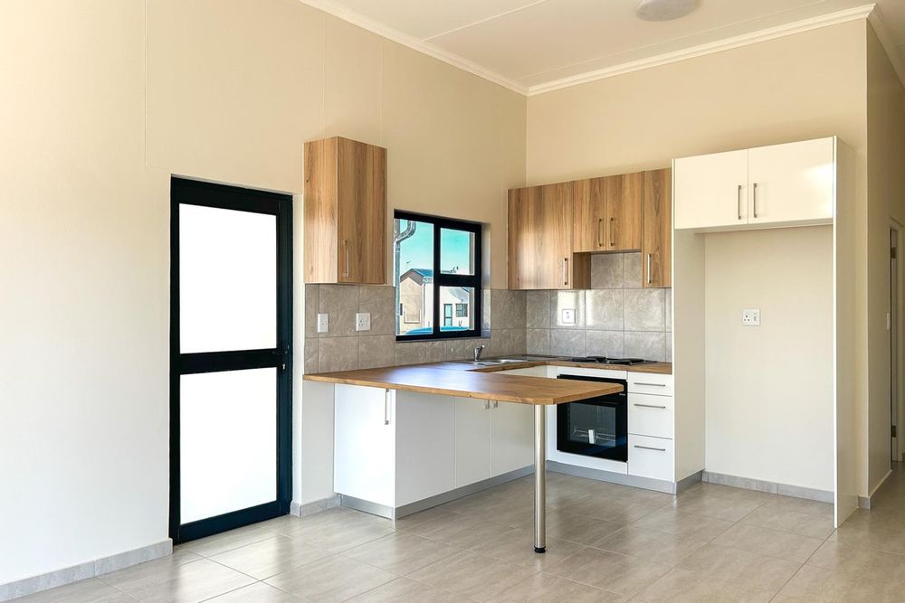 Modern kitchen with built-in cupboards and oven.