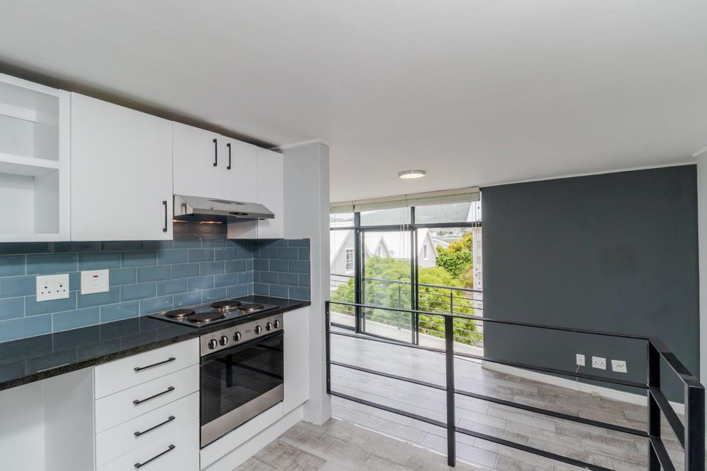 Kitchen has hob, extractor fan and under counter oven