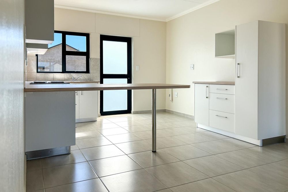 Kitchen with built-in cupboards and oven.