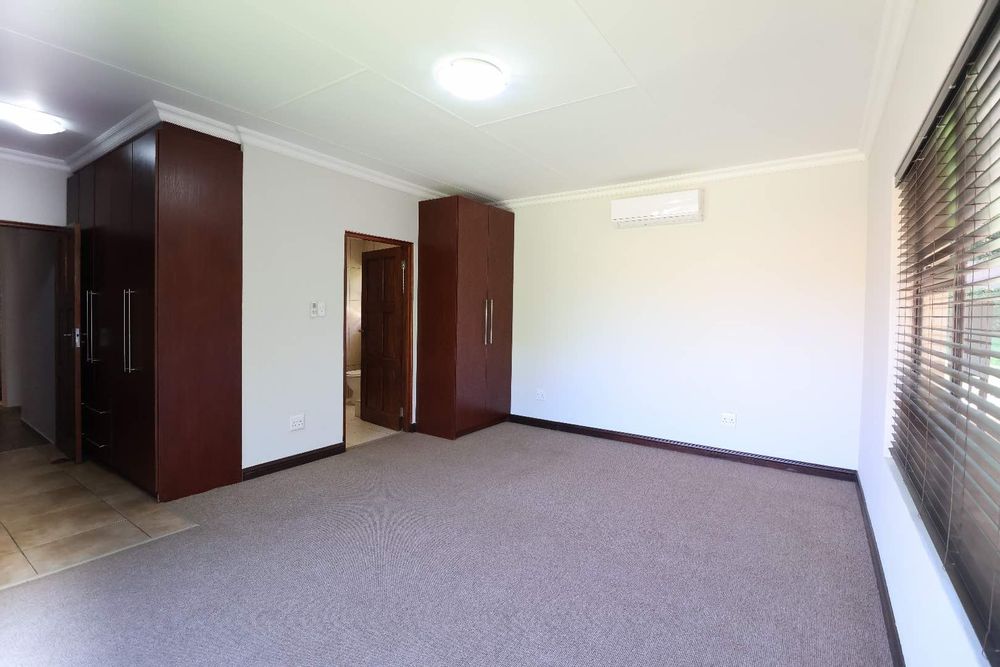 Main bedroom with built-in cupboards and air-conditioner