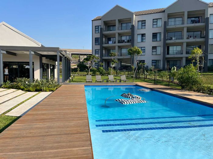 Ballito Central Apartment For Sale: Eco-friendly, pool, gym, clubhouse, secure parking.