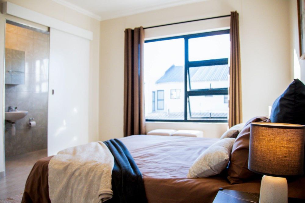 Main bedroom with built-in cupboards and ensuite bathroom.