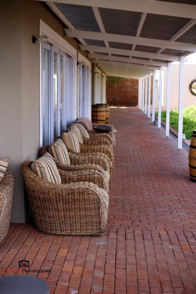 Relaxing chairs around the swimming pool