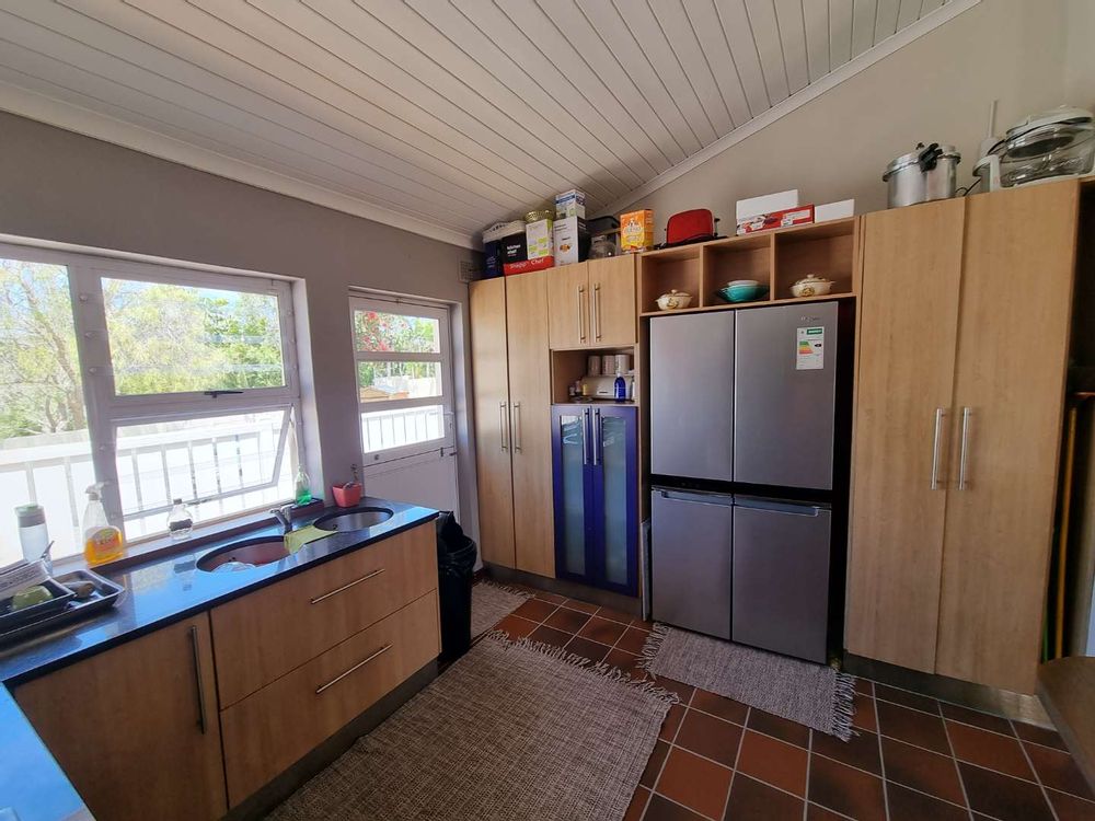 Modern kitchen with gas stove and granite tops.