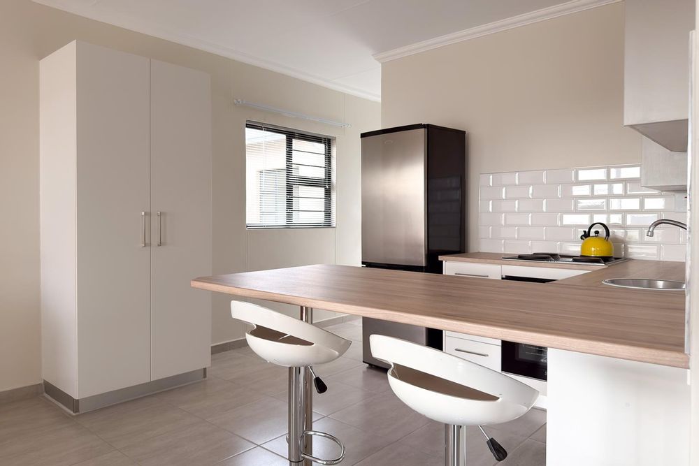 Modern kitchen with plenty of cupboards and separate, kitchen scullery.