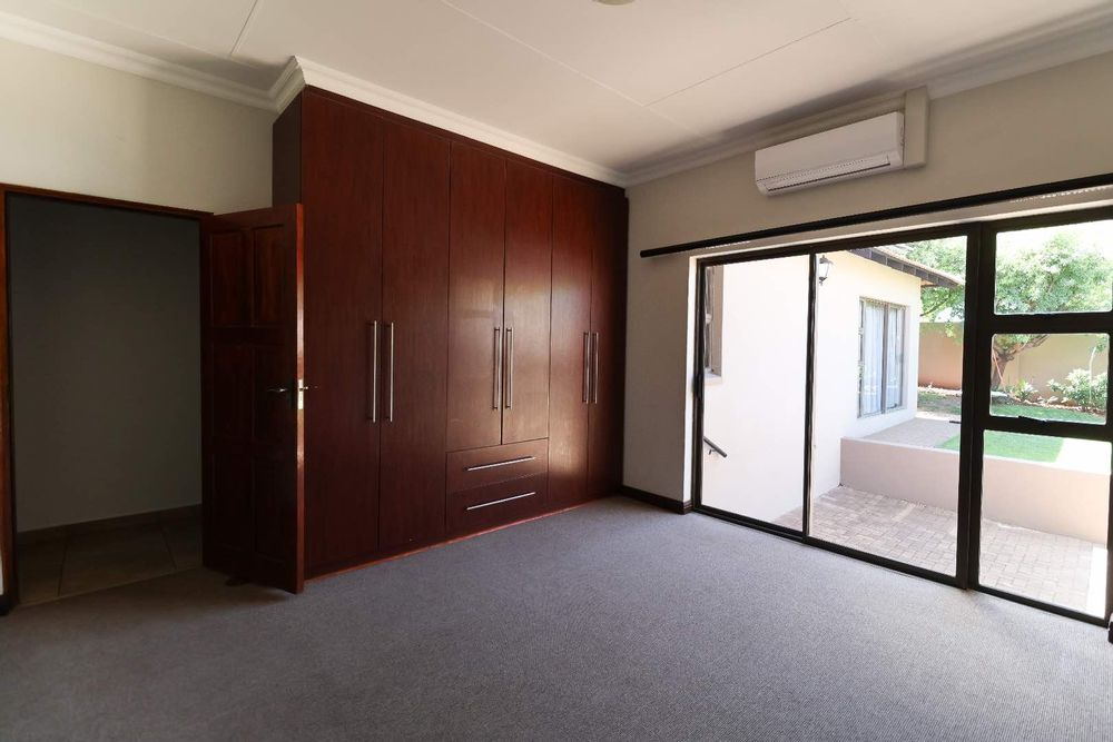 1st Bedroom with built-in cupboards and air-conditioner