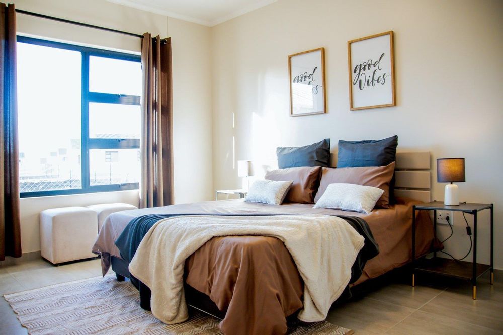 Main bedroom with built-in cupboards and ensuite bathroom.