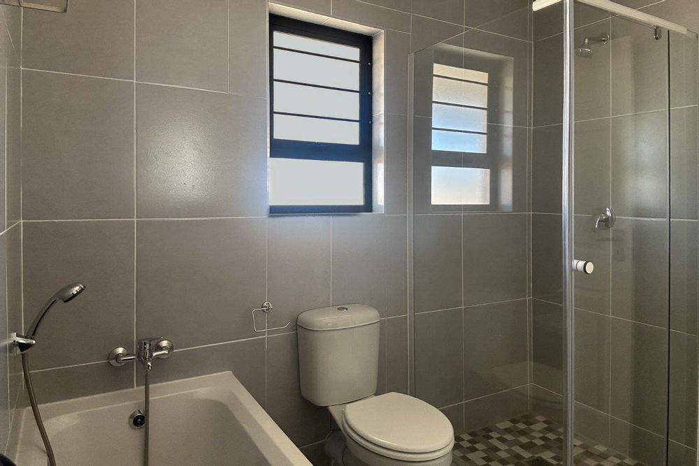 Family bathroom with bath and shower.