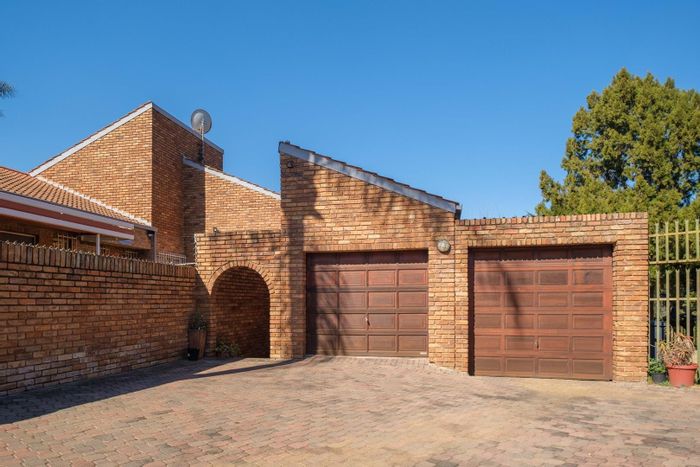 Garsfontein Townhouse For Sale: Spacious living, solar power, and private garden.