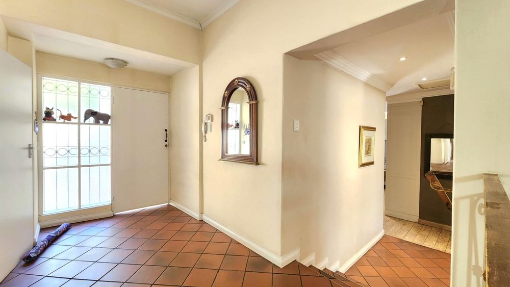 Entrance hall from interior landing, guest toilet to the left.