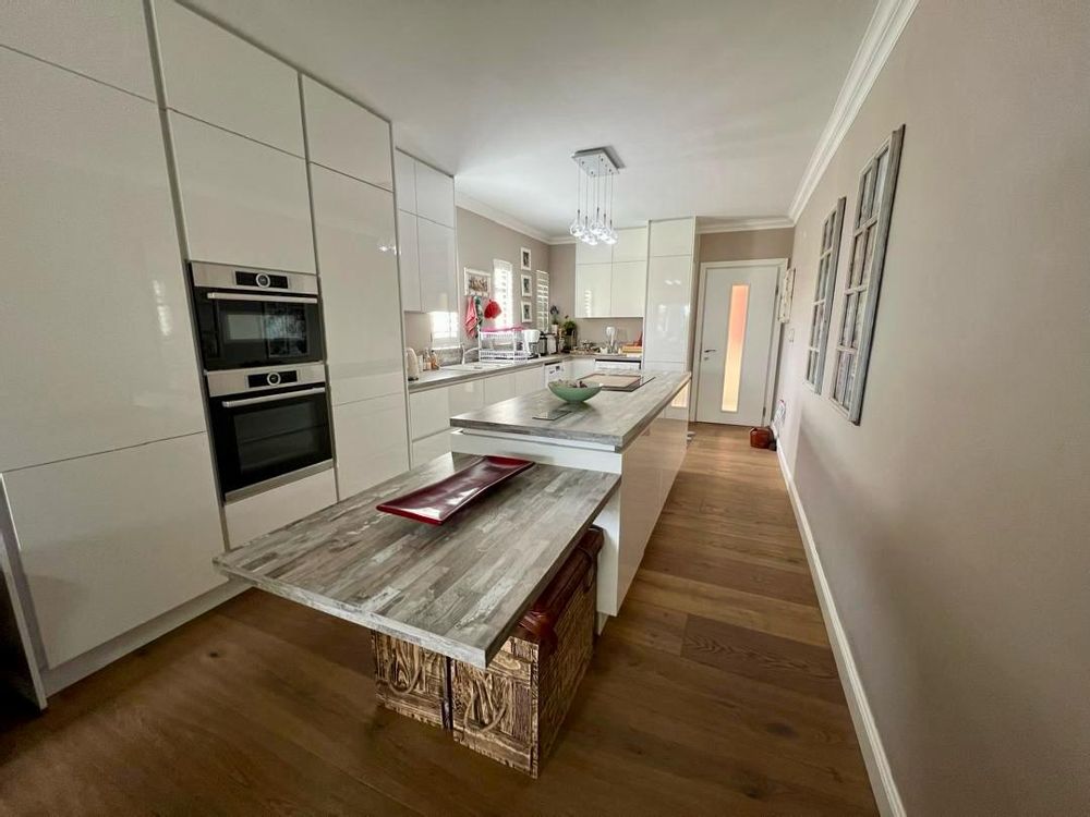 Kitchen with built-in cupboards, oven and stove