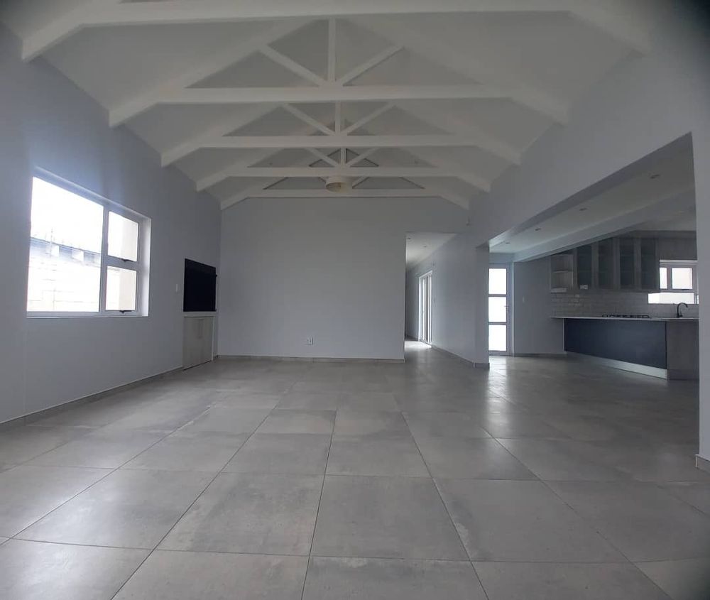 Open-plan kitchen/ lounge/dining area with indoor BBQ area