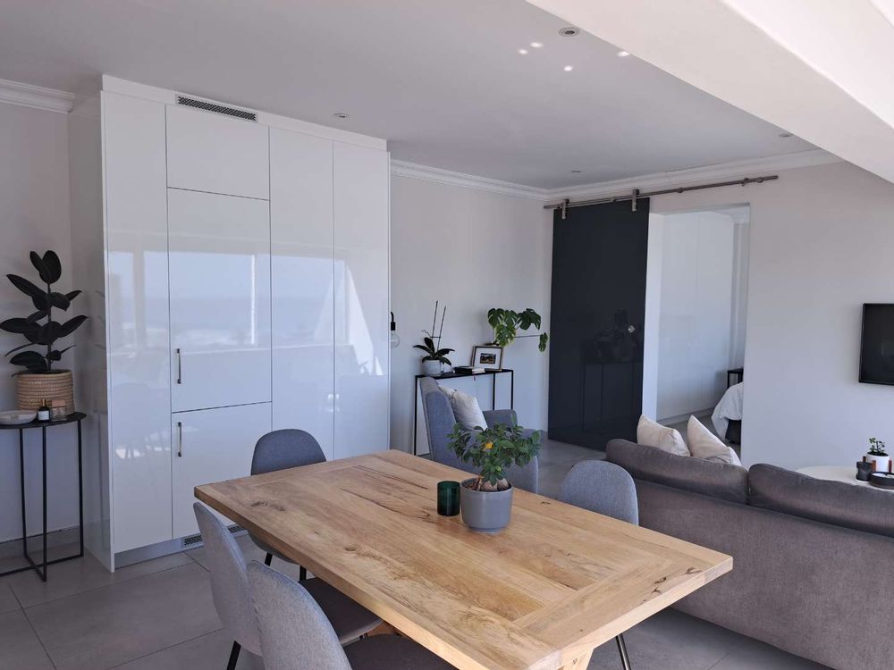 Open lounge and dining with built in cupboards (with integrated fridge)