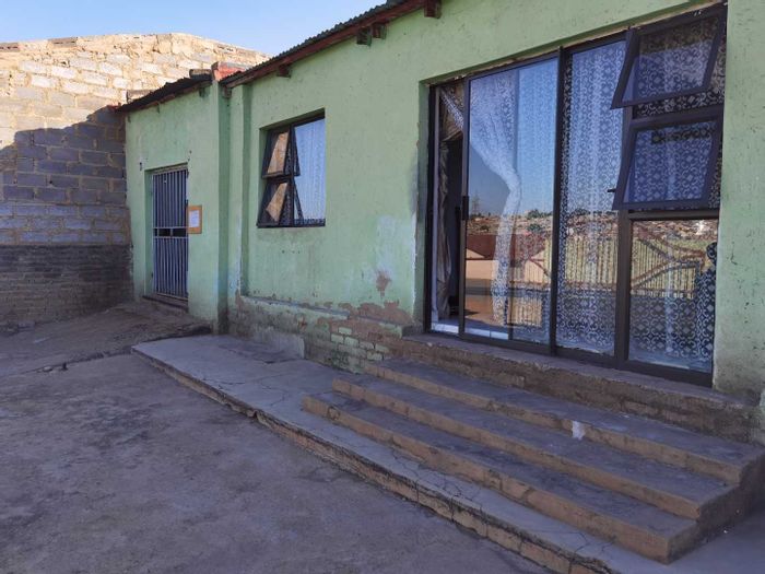 For Sale: Tembisa Central house with 4 outside rooms, garage, and tiled kitchen.