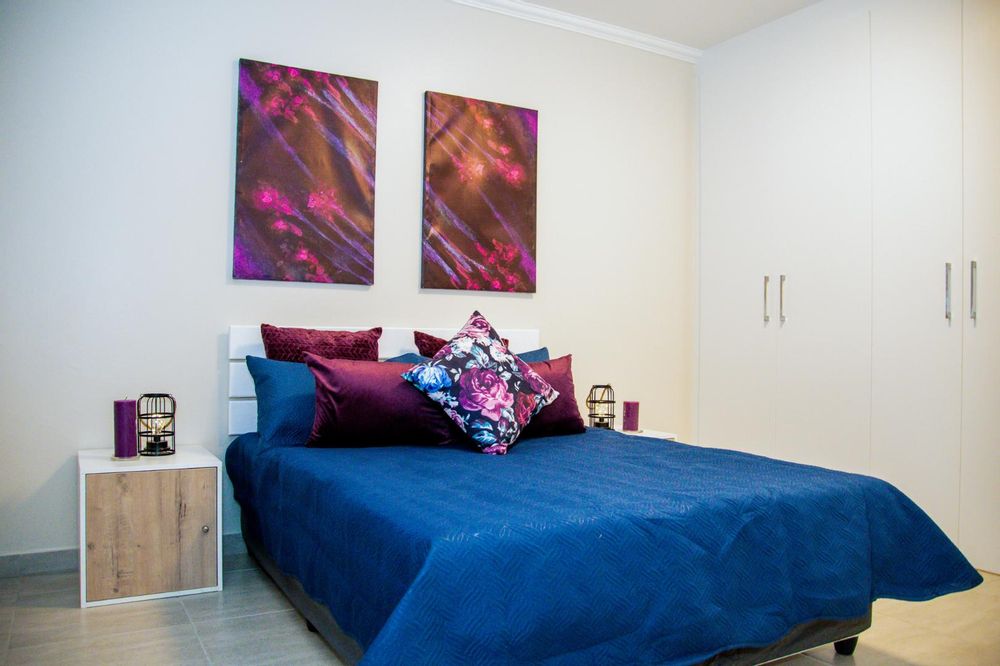 Main bedroom with built-in cupboards and ensuite bathroom.