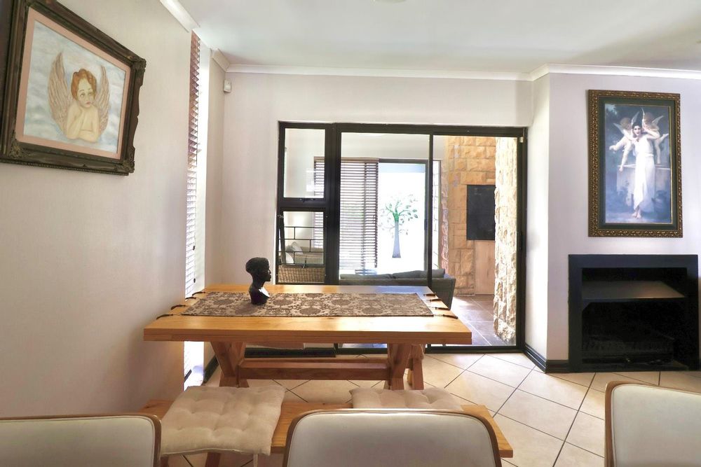 Dining area and patio with built-in braai, as seen from kitchen