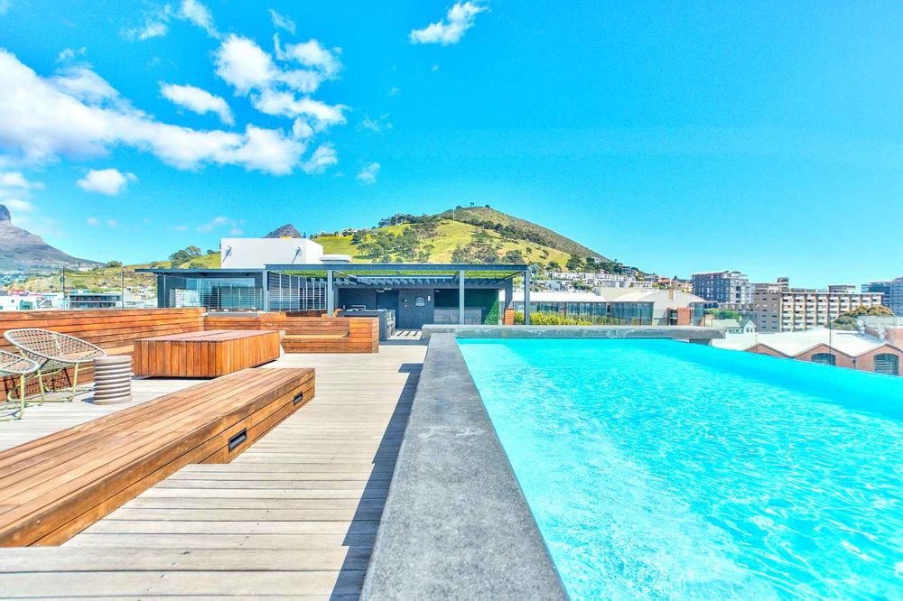 communal rooftop pool deck with iconic views, gas braais and private bar