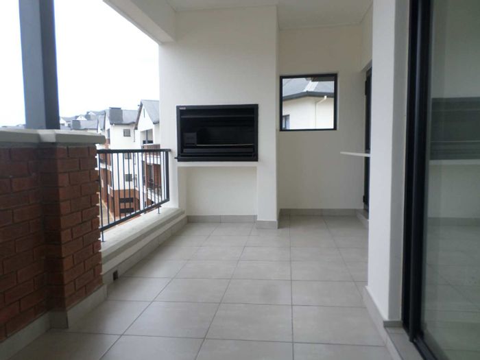 Ballito Central Apartment To Rent: Top-floor unit with balcony, gym, and pool access.