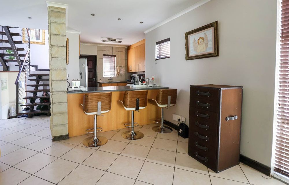 Open-plan dining area (alternative furniture layout) and kitchen, and staircase