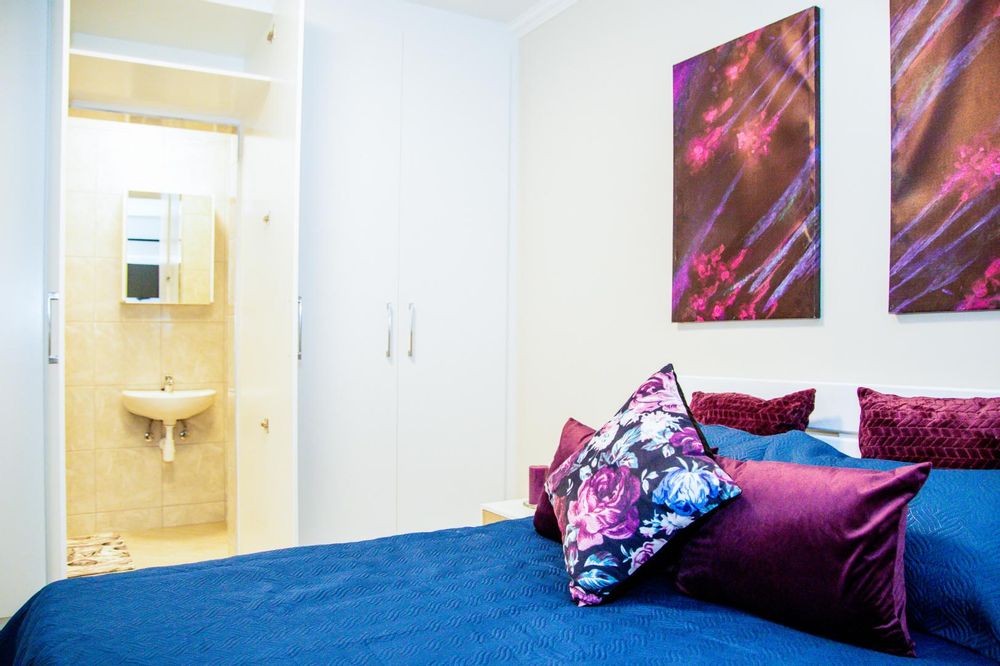 Main bedroom with built-in cupboards and ensuite bathroom.