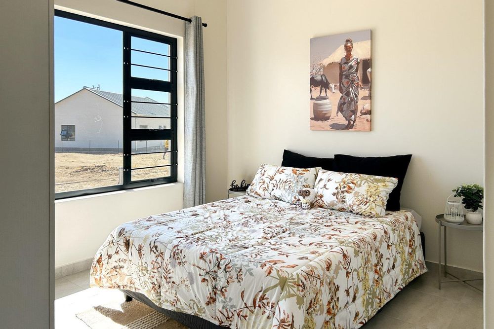 Spacious second bedroom with built-in cupboards.