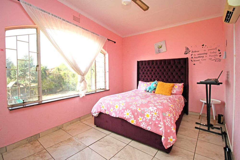 Bedroom 1 : Main Ensuite Bedroom with walk-in Dressing Room with His& Hers Built-In Cupboards, A Full Bathroom and a Balcony that overlooks the expansive Garden Terrace