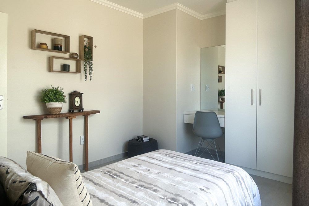 Second bedroom with built-in cupboards.