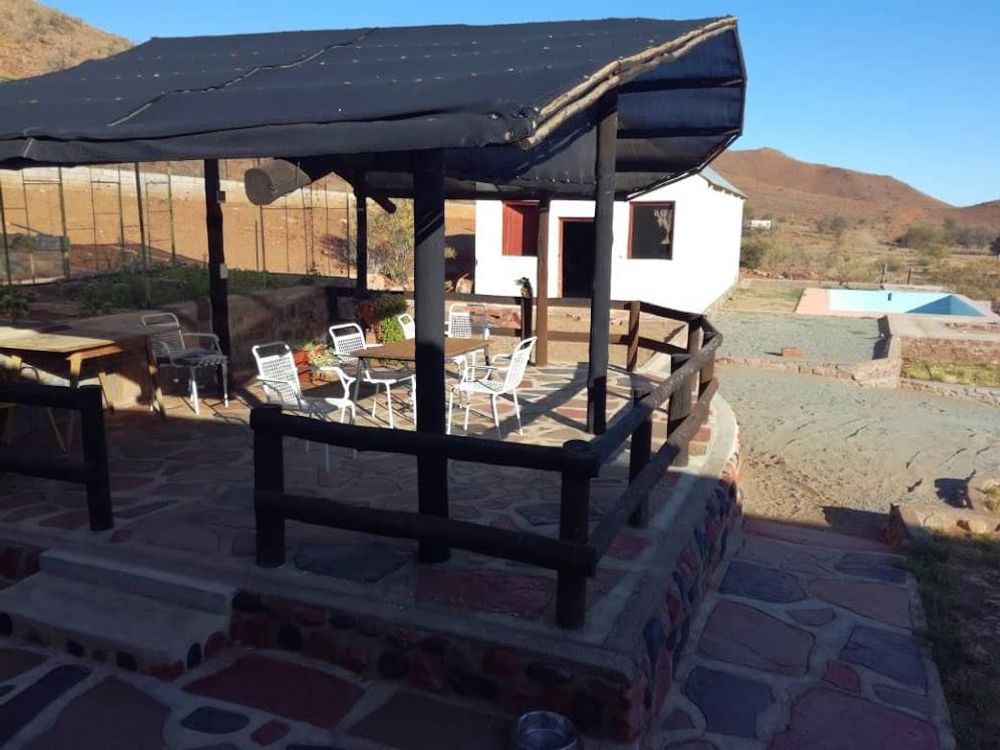 Covered Lapa with seating area and a pool in the background
