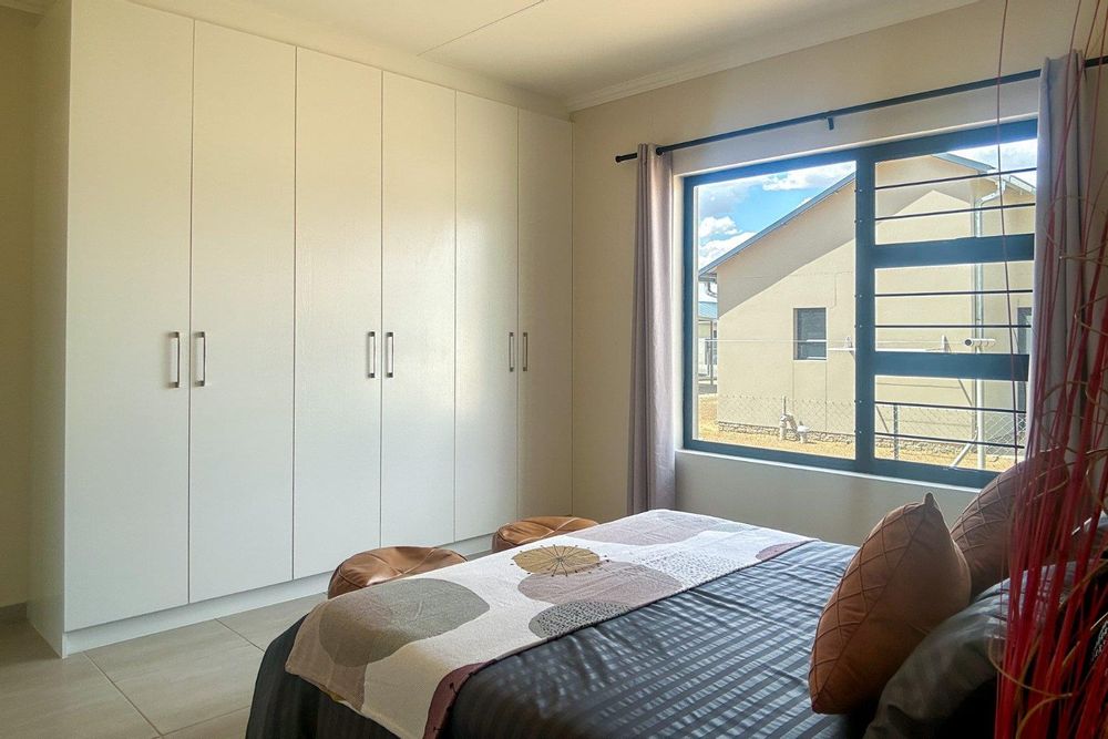 Spacious main bedroom with built-in cupboards and ensuite bathroom.