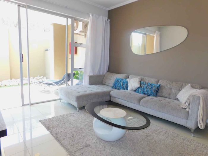 Furnished Bryanston apartment to rent: 2 beds, garden, pool, parking included.