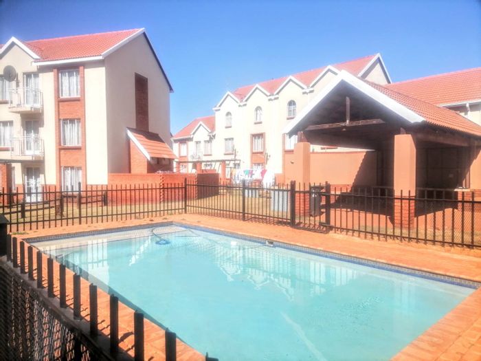 Akasia Central Apartment For Sale: 2-bed, pool, braai area, covered parking.
