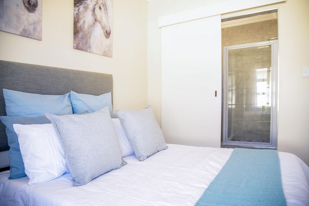 Main bedroom with built-in cupboards and ensuite bathroom.