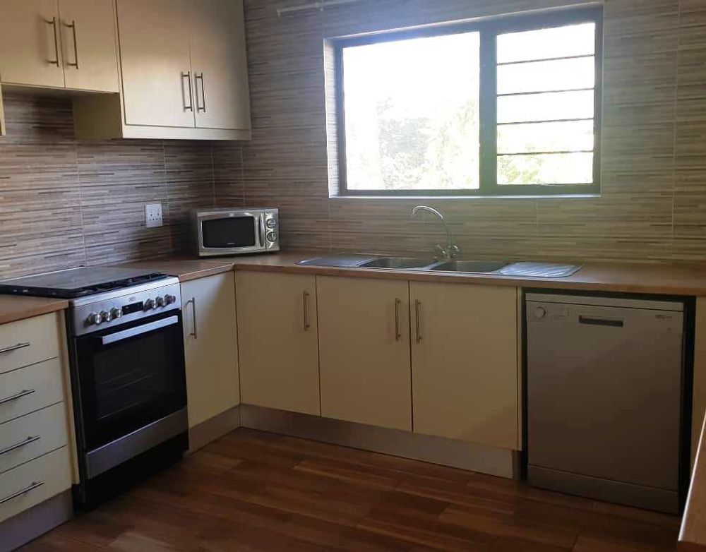 Beautiful open plan kitchen with lots of cupboards.