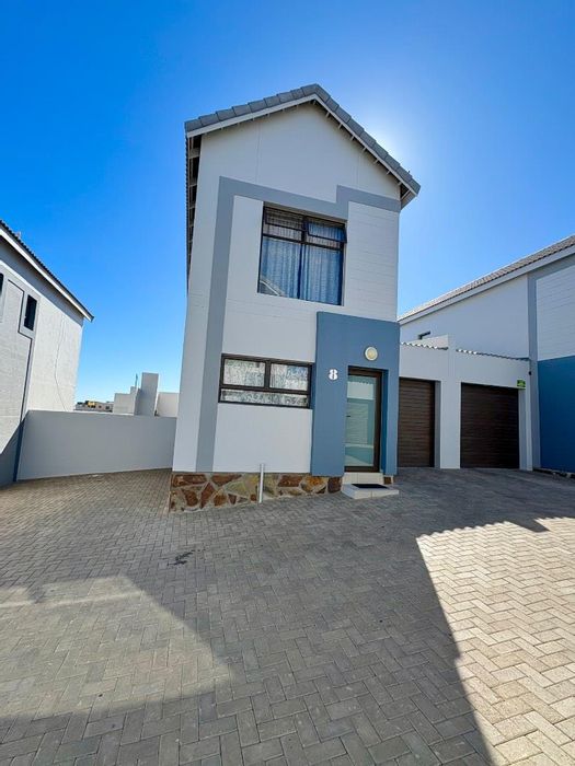 2-Bedroom Townhouse For Sale in Dolphin Beach with outdoor BBQ and tandem garage.