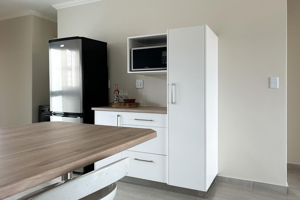 Kitchen with plenty of built-in cupboards and a built-in oven.