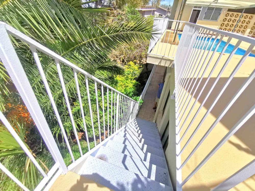 STAIRCASE GOING DOWN TO POOL PUMP AREA AND WATER TANKS AND ANOTHER FLATLET 