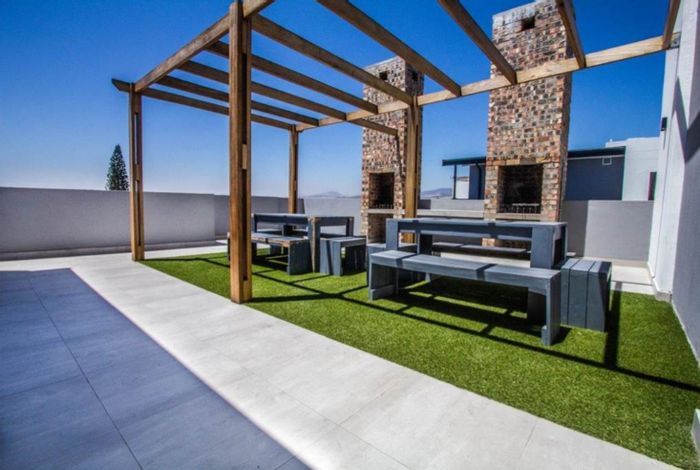 Pet-friendly Table View apartment for sale with rooftop braai and included appliances.