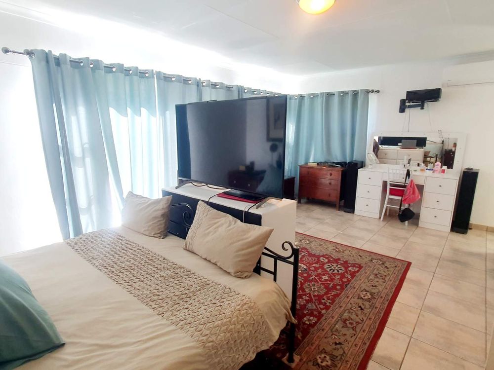 Spacious main bedroom with balcony