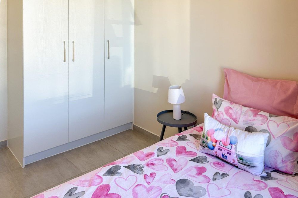 Second bedroom with built-in cupboards.