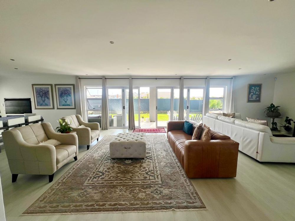 Open-plan lounge with French doors leading to the beautiful garden