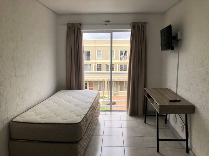 La Colline Apartment To Rent: Furnished bachelor unit with essential amenities and workspace.