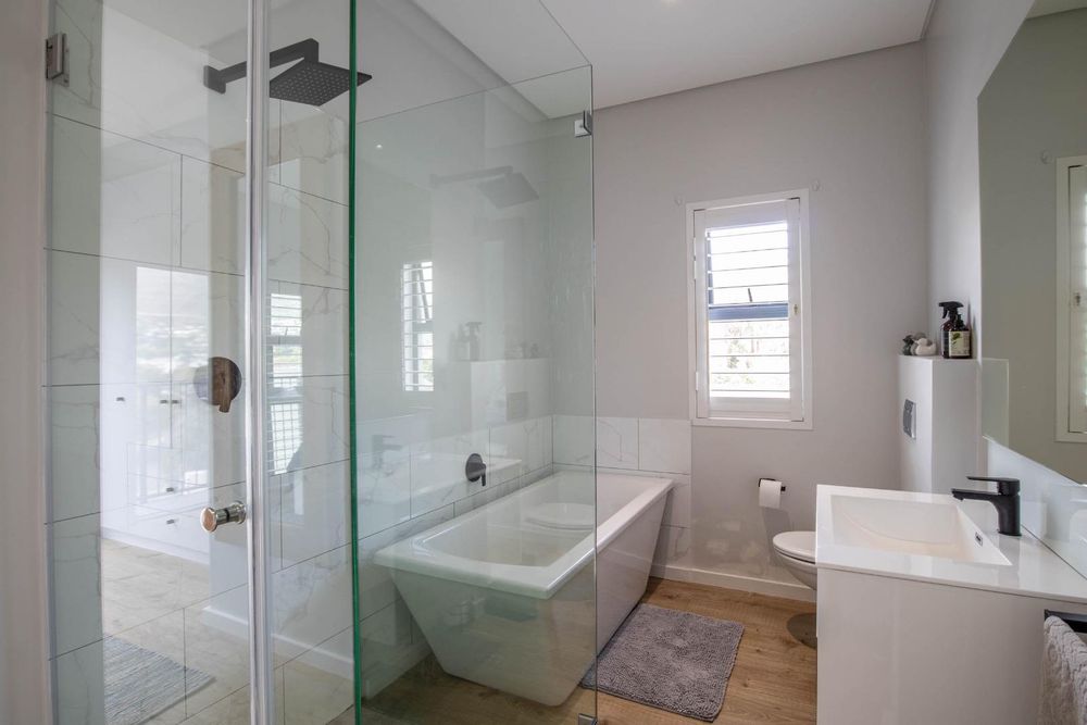 Main bathroom with bath and shower, neutral colours